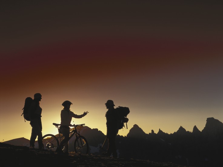 Cyclists silhoueted at sunset
