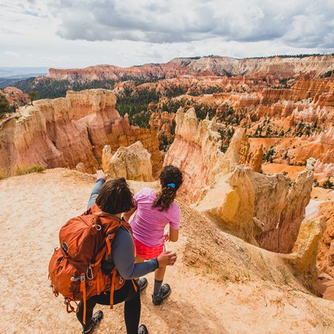 A mother and daughter look out at the hoodoos in Bryce Canyon National Park.